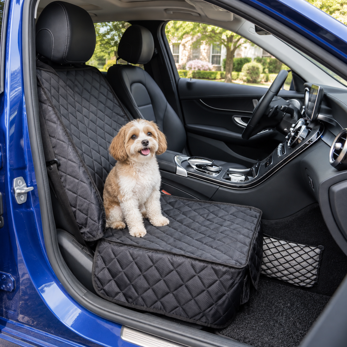 Small dog sitting on a Black quilted vehicle seat cover in the front passenger seat - Ravzelo
